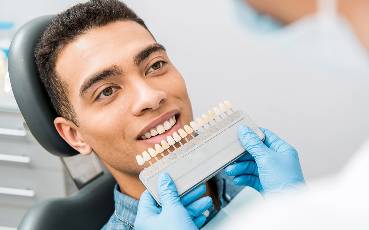 man doing dental implants at the dentist