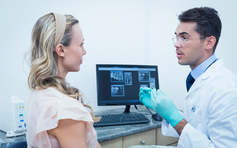 dentist talking to patient technology