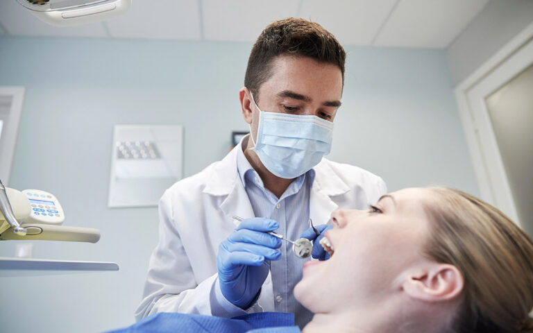 dentist checking patient teeth