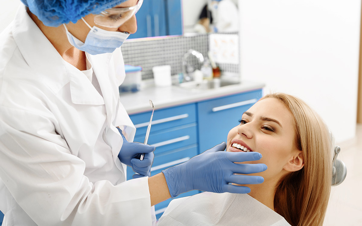 dentist checking patient teeth and bite