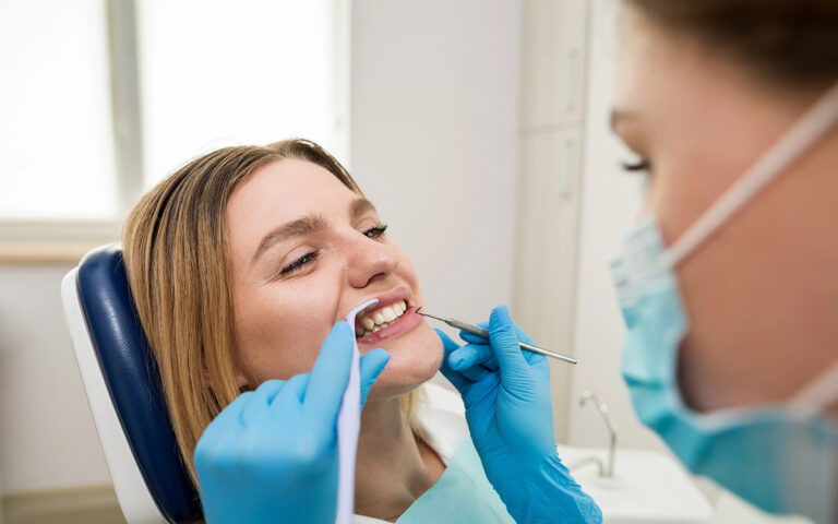 dentist checking young patient teeth