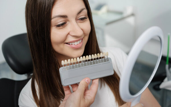 woman at the dentist looking at veneers colors