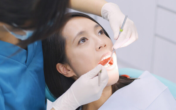 Dentist examining a patient teeth in the clinic