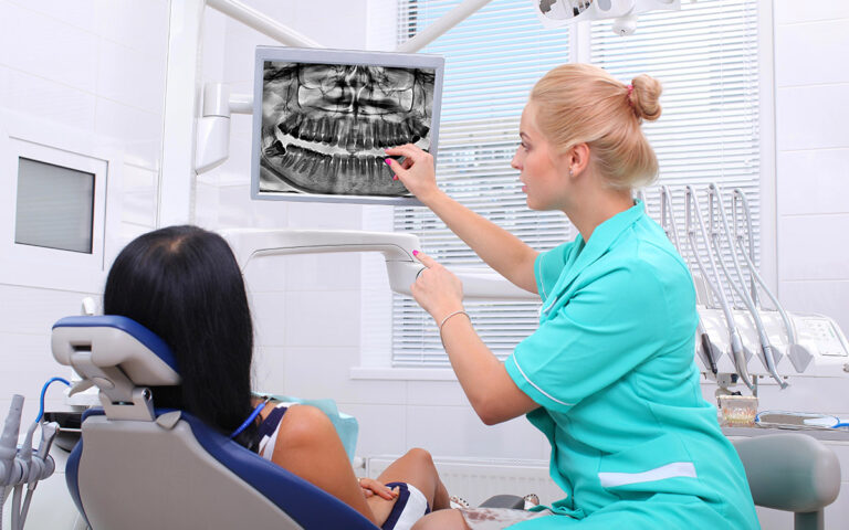 woman at the dentist looking at her xrays